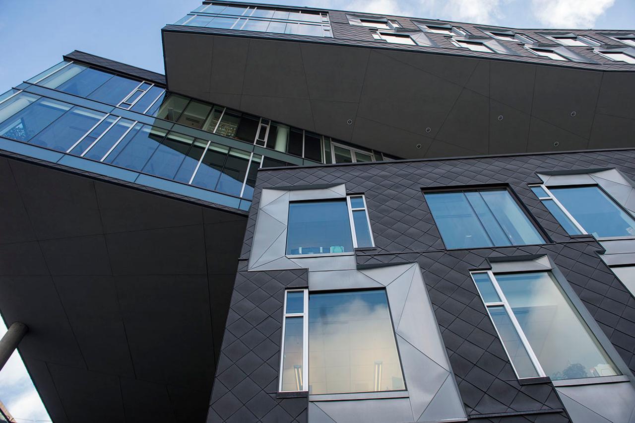  A shot of the Gates-Hillman Center, a mostly glass building, looking up at it from below.